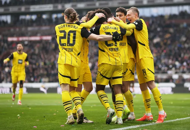 Borussia Dortmund players in training, getting ready for an upcoming UEFA Champions League match, wearing the team's training kits and focused on tactics and drills.